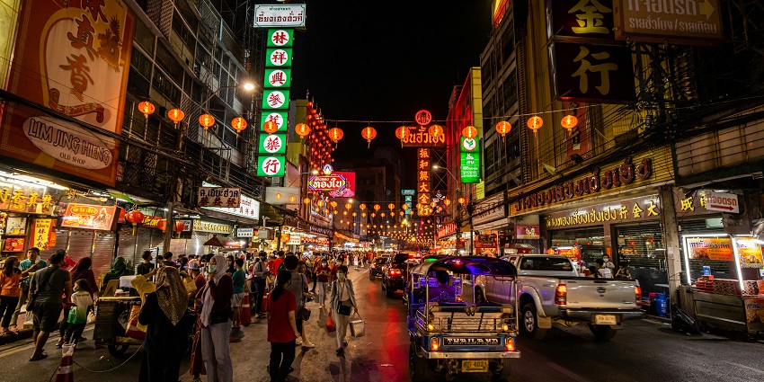 Tourists wandering around the streets, exploring cafes and shops near the bridge