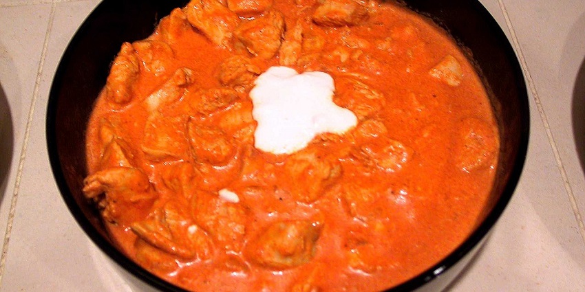 An image showing Chicken Paprikash, the best food in Hungary, served with pasta.