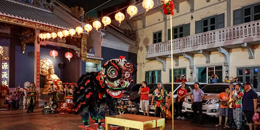 Crowd clicking pictures during Chinese New Year celebration with festive decorations