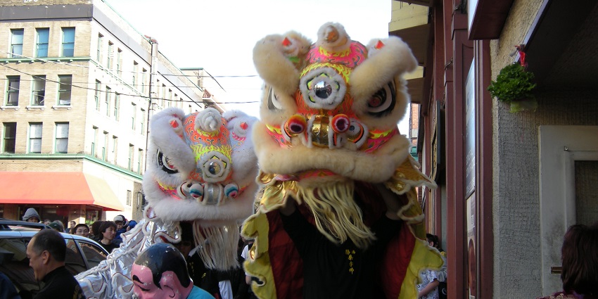 Chinese New Year in Seattle, with people wearing a dragon-like mask during the parade