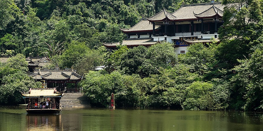 Tourists exploring the lake at the base of Mount Qingcheng, a fun thing to do in Sichuan.