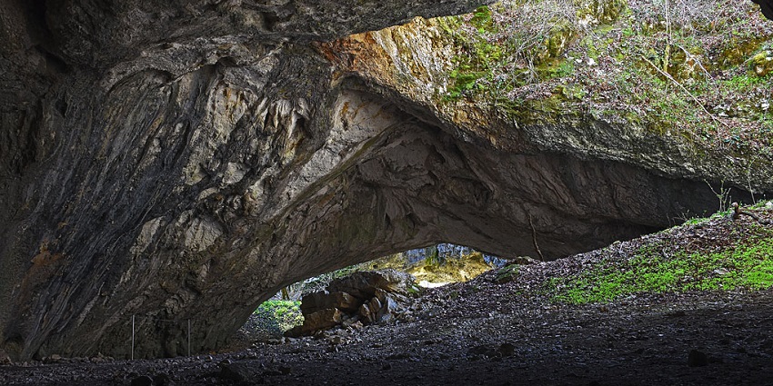 An image of Black Cave, displaying its dark and rugged interior with natural formations.