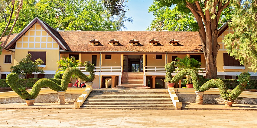 Exterior view of Dak Lak Museum with intricate architecture and greenery around.