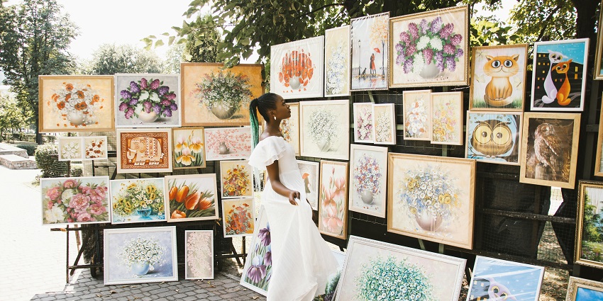 View of a woman exploring the beautiful art display on the streets during Dakar Biennale
