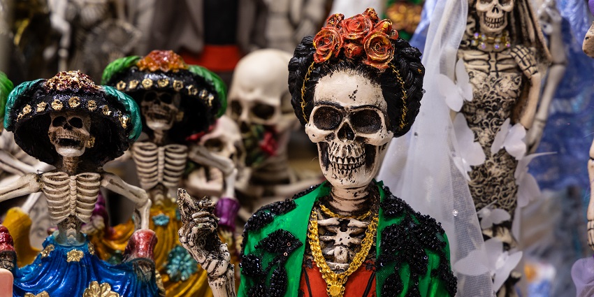 Several skeleton dolls with each wearing unique clothes are placed on display