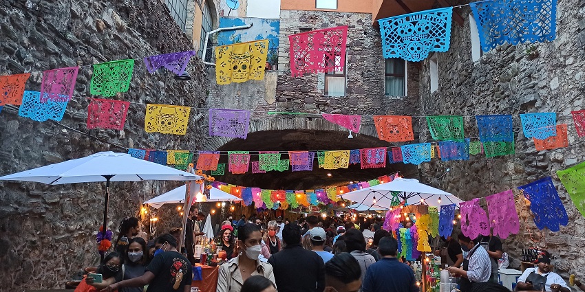 Decorated streets and people celebrating the Day of the Dead, a festival in Mexico.