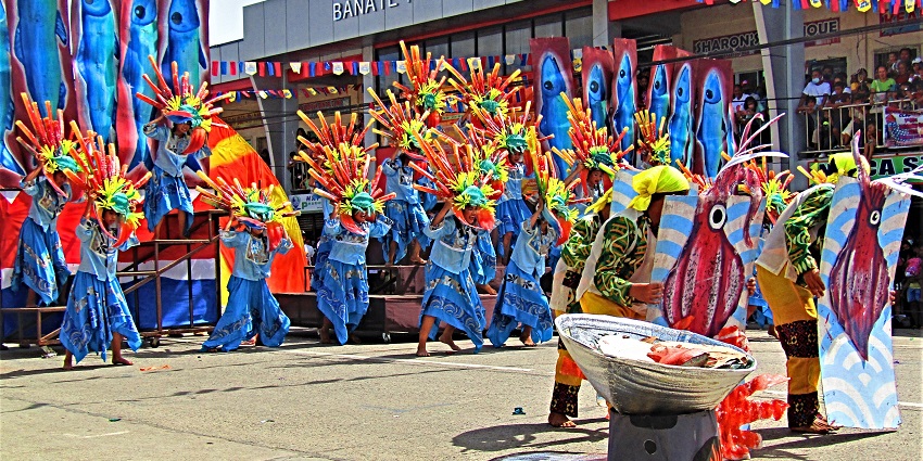 Masked performer in traditional attire celebrating the Deing Culture Festival, a must-visit festival in Indonesia