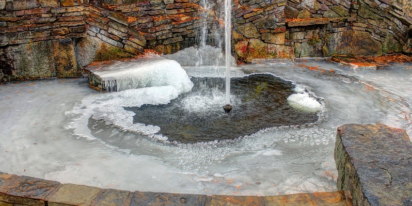 Image of a stunning natural hot spring fountain in the lush green natural surrounding