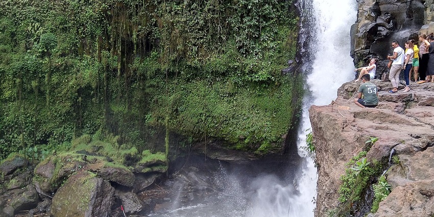 A stunning view of Tegenungan Waterfall in Bali, Indonesia surrounded by lush greenery