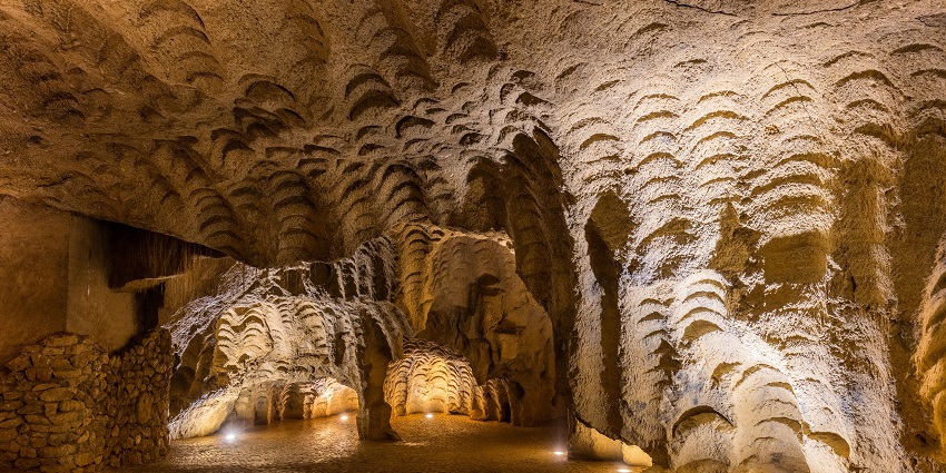 An inside view of the Caves of Hercules exuding historical elegance and rustic charm.