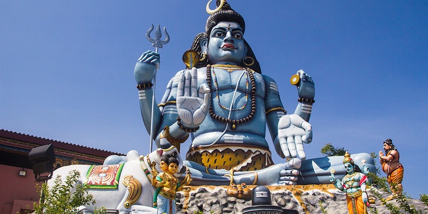 Vibrant Dravidian-style temple perched on a cliff with panoramic ocean views.
