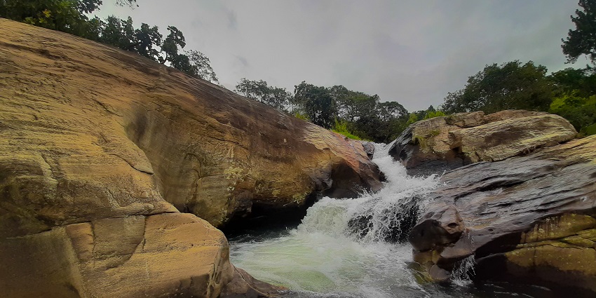 Water at the Diyaluma Falls in Ella, Sri Lanka, makes its way between the large rocks.
