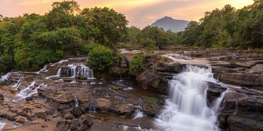 Wide view of Ekom Nkam Waterfalls cascading through lush green forest in Cameroon, one of the best waterfalls in Cameroon.