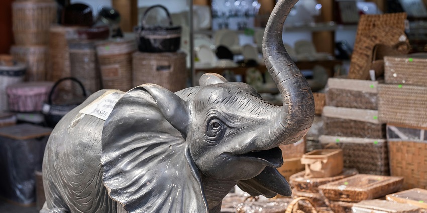 image of wooden elephant figurines representing one of the best things to buy in Thailand.