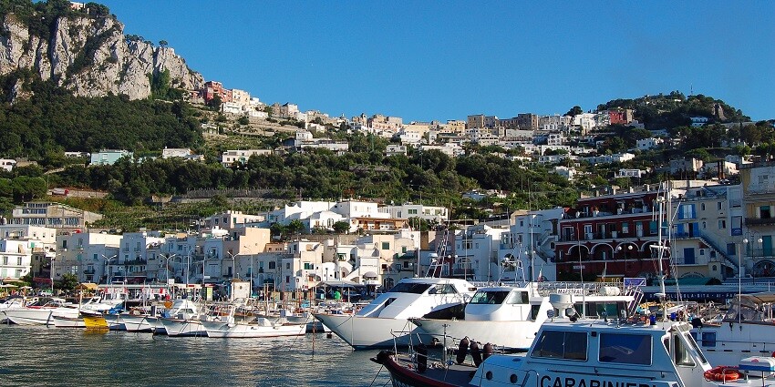 Take a scenic boat ride around the island, known for its crystal-clear waters and dramatic cliffs.