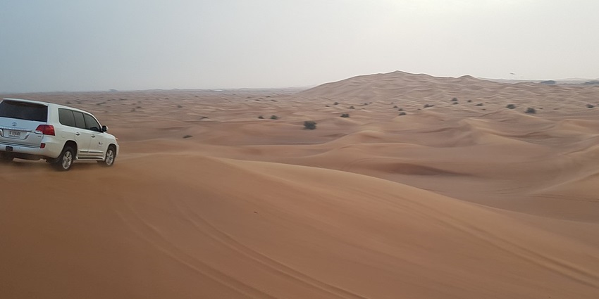 An image of people in a vehicle on a desert safari, one of the things to do in Abu Dhabi in January.