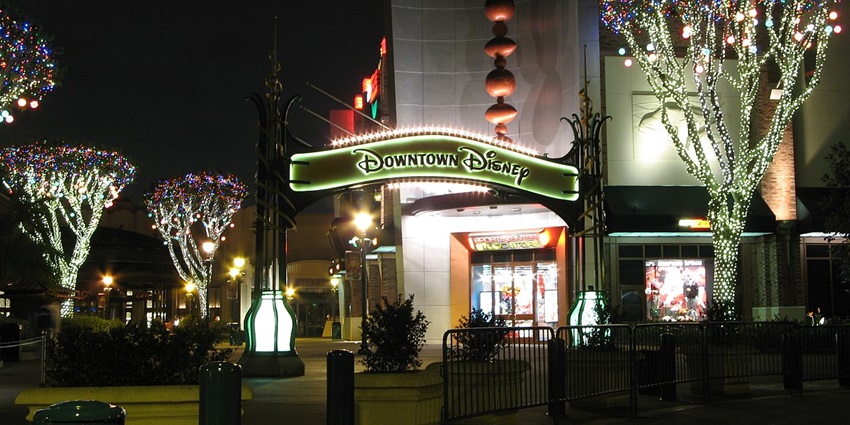 A lit-up pathway of Downtown Disney District, offering many things to do in Anaheim at night.