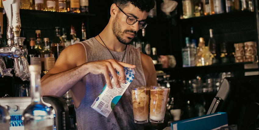 A person making a drink at Orchid Cocktail Bar, one of the popular things to do in Aberdeen at night.