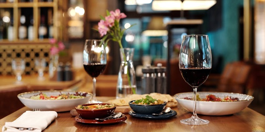 A fine dining experience with top wine enjoyed by guests at Symposium Cafe Restaurant Ajax