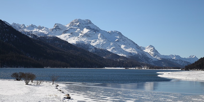 Adventurers enjoying windsurfing and kitesurfing on the breezy Lake Silvaplana.