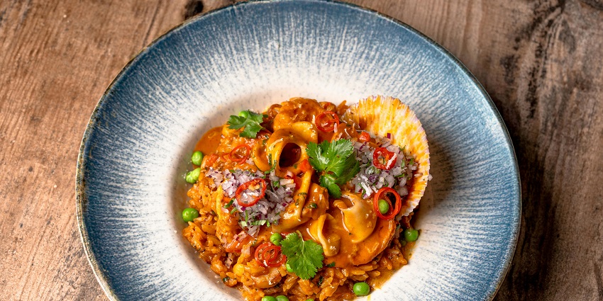 An image of stylish dining of risotto at Enoteca Pinchiorri, serving delicious food in Italy.