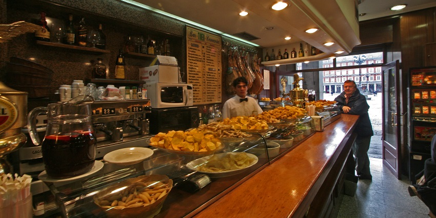Granada bars serve free tapas with drinks, highlighting regional traditions of social dining and culinary variety.