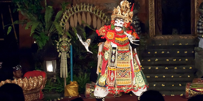 A traditional Balinese dancer performs gracefully in Ubud, Bali, Indonesia for the audience