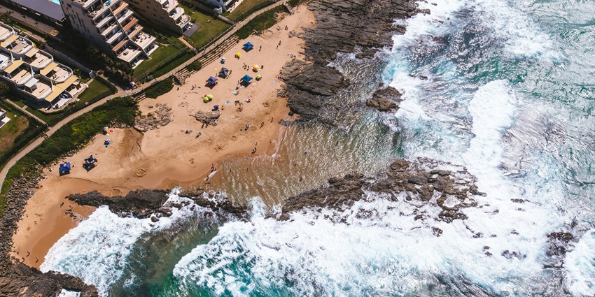 Scenic view of Durban Beach with golden sands, rolling waves, and a vibrant coastline.