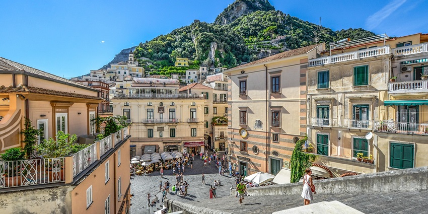 An image of one of the charming squares in Amalfi Town, with cafes and historic buildings.