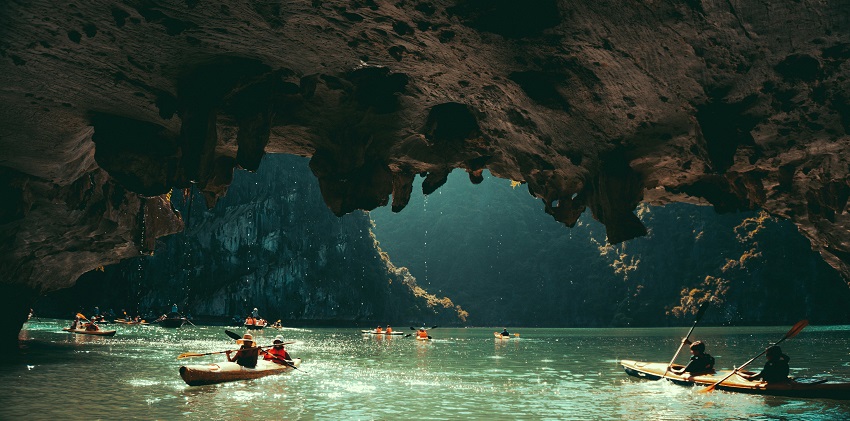 Canoeing through Luon Cave in Ha Long Bay, Vietnam, reveals hidden natural wonders.