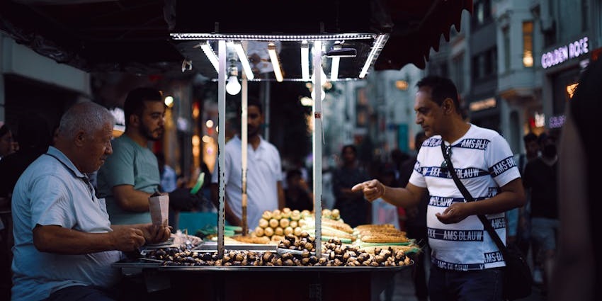 A tourist tasting the street food at night, an exciting thing to do in Broome, Australia.