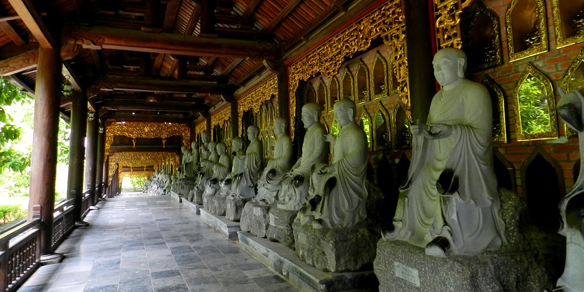 Image of inside the halls of Temples Of Bai Dinh, with beautiful sculptures lining