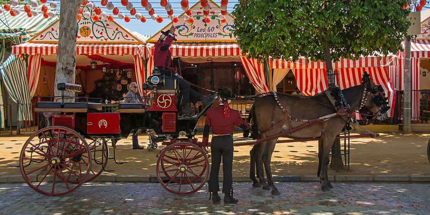 A decorated horse carriage stands ready, surrounded by vibrant tents and festive lanterns.