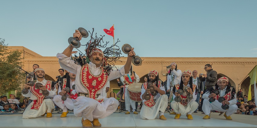An image of musicians on a stage in front of city walls during the Fes Festival of Sacred Music.