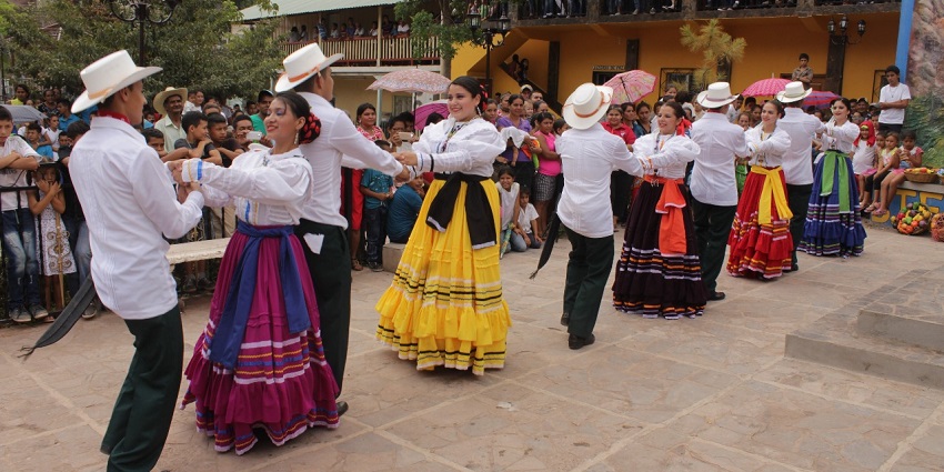 Performers in traditional dress celebrate Honduran folklore with music and dance.