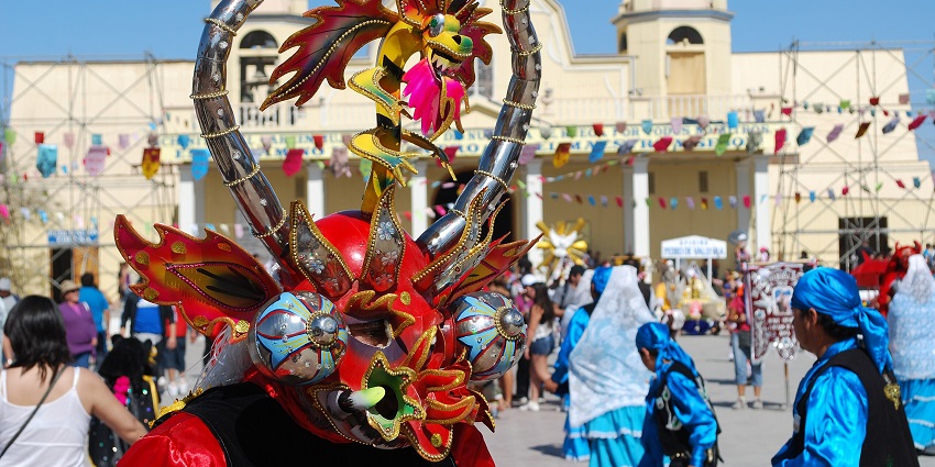 Dancers in bright costumes perform in the streets during the La Tirana festival in northern Chile.