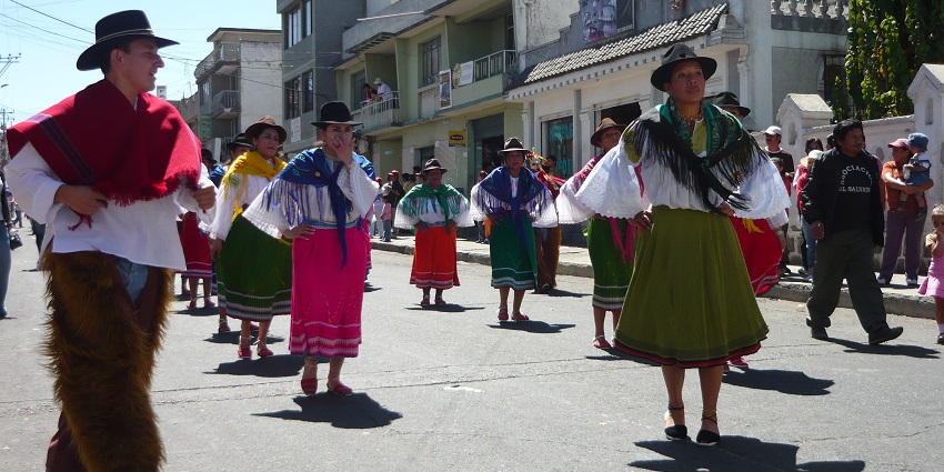 Locals celebrate Quito’s founding on chiva buses with music, costumes, and joyful crowds during Ecuadorian festivals.