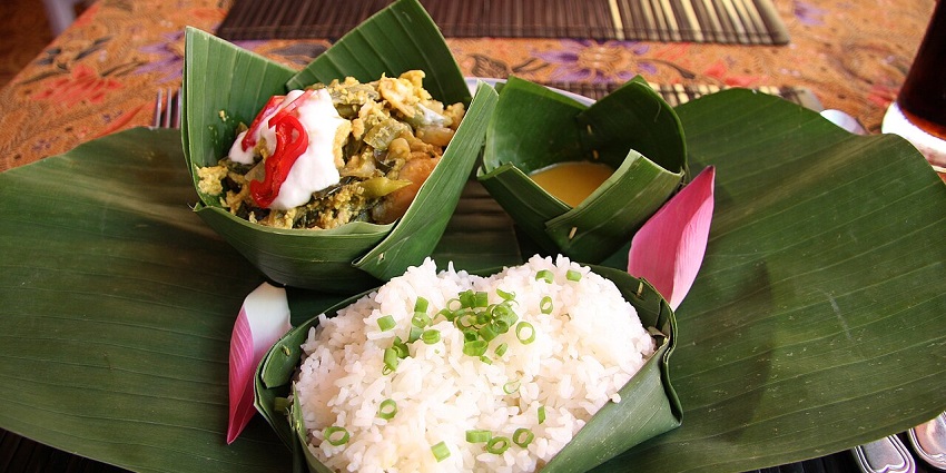 An image of fish amok, a creamy curry dish served in a banana leaf bowl, is one of the best food in Cambodia.