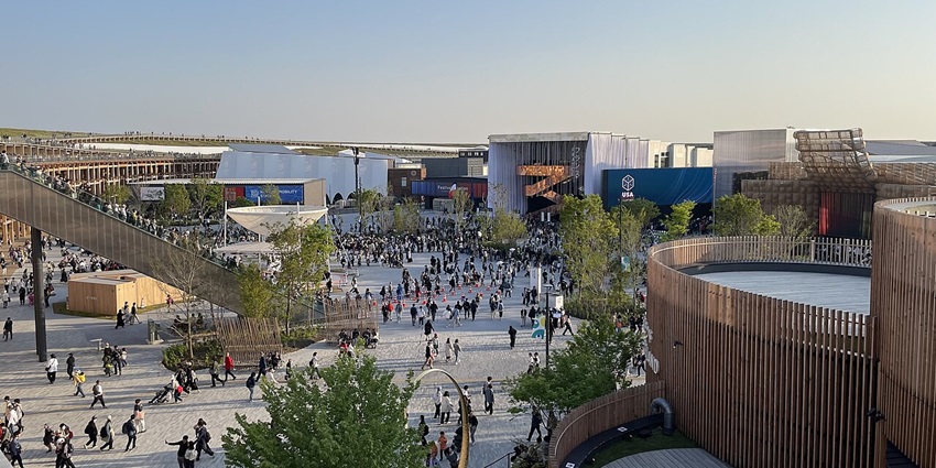 Plaza at World Expo 2025 with a crowd of people, multiple ongoing exhibitions and pavilions