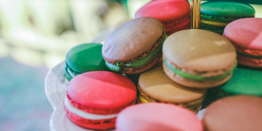 Image of a couple of French macarons on a plate, one of the best things to buy in Paris.