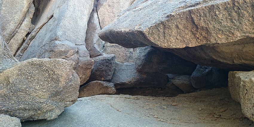 An image of the wide open space inside the stunning Ghara Cave with scattered sunlight.