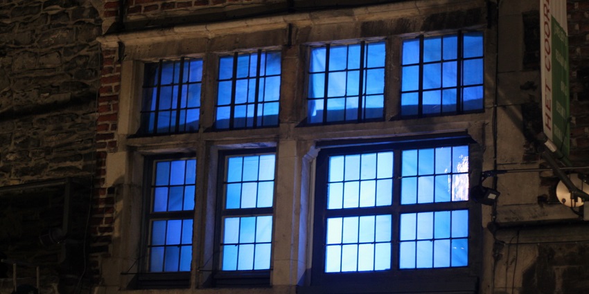 A scenic view of a lighted building amidst the Ghent Light Festival decorations.