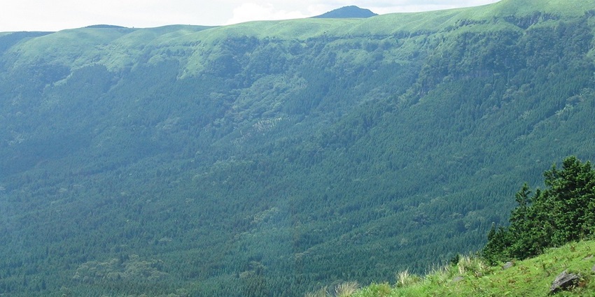 An image showcasing the edge of Aso caldera, riding here is one of the best things to do in Aso