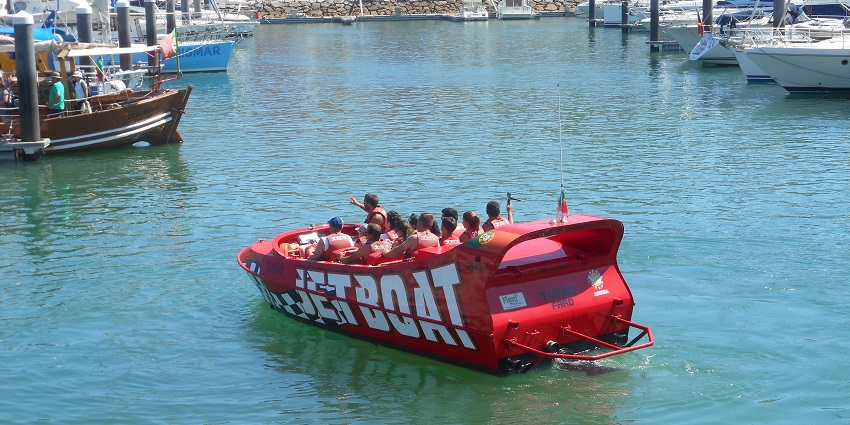 An image of people taking a boat tour to spot dolphins, one of the best things to do in Albufeira.