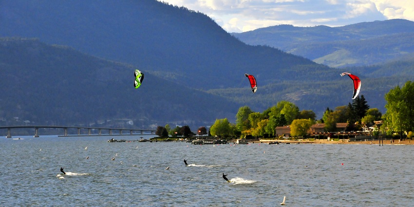 Serene view of the Okanagan Lake, with the verdant mountains in the background