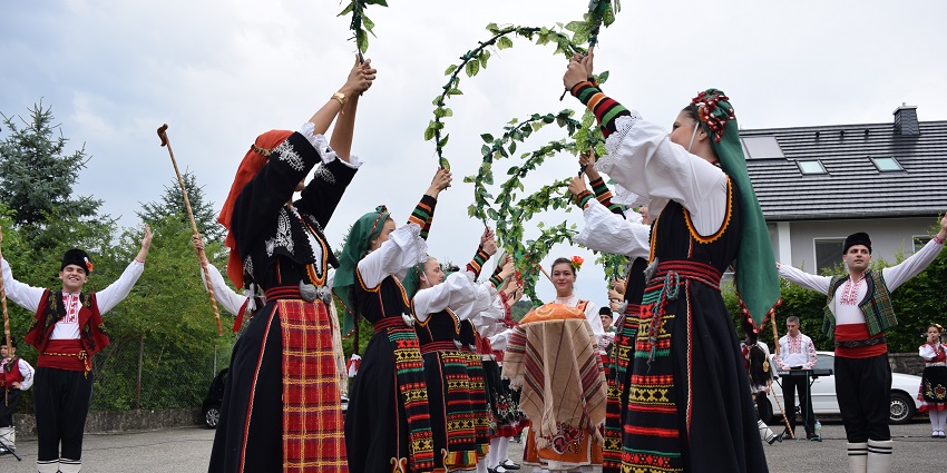 Gleeful men and women in stunningly beautiful attire at the Goree Diaspora Festival