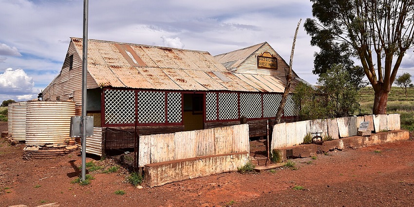 An eerie mining town with crumbling buildings and empty streets, echoing Tasmania’s industrial past.