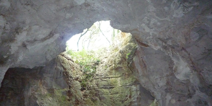 An image of Illuminated stalactites in Grotte des Demoiselles cave in France.