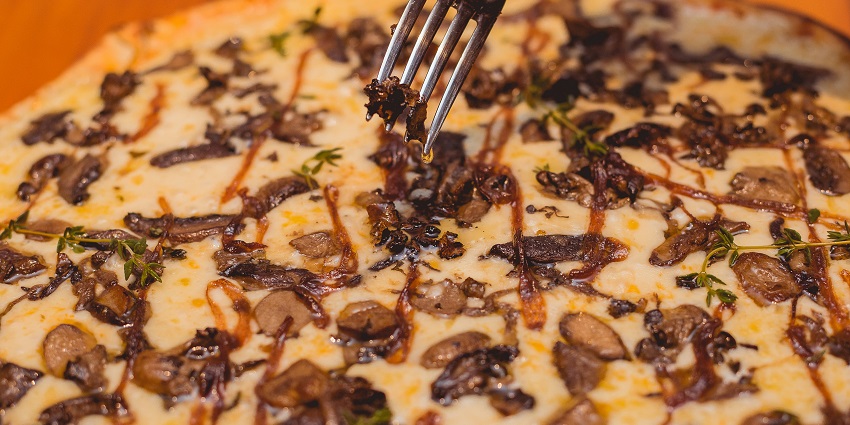 An image of a sophisticated black truffle pizza in Guy Savoy, the epitome of food in France.