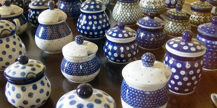 Hand-painted ceramic bowls and plates with Thai motifs arranged in rows are unique things to buy in Pattaya.